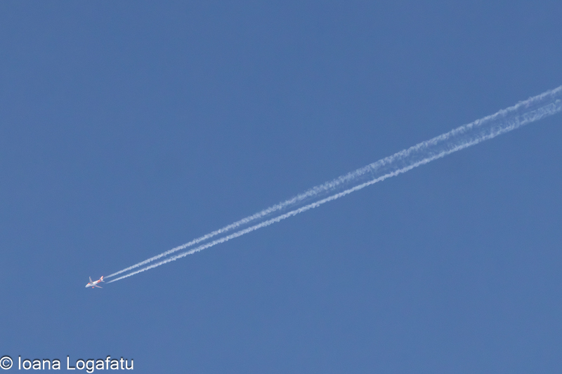 Jet leaving trails in the clear blue sky above